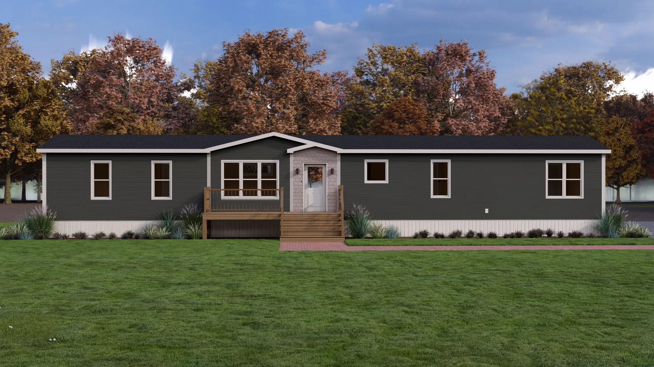 Front elevation of a contemporary mini home featuring dark charcoal siding, a central entry porch with wood railings, decorative shingle accents, and landscaped foundation beds. 