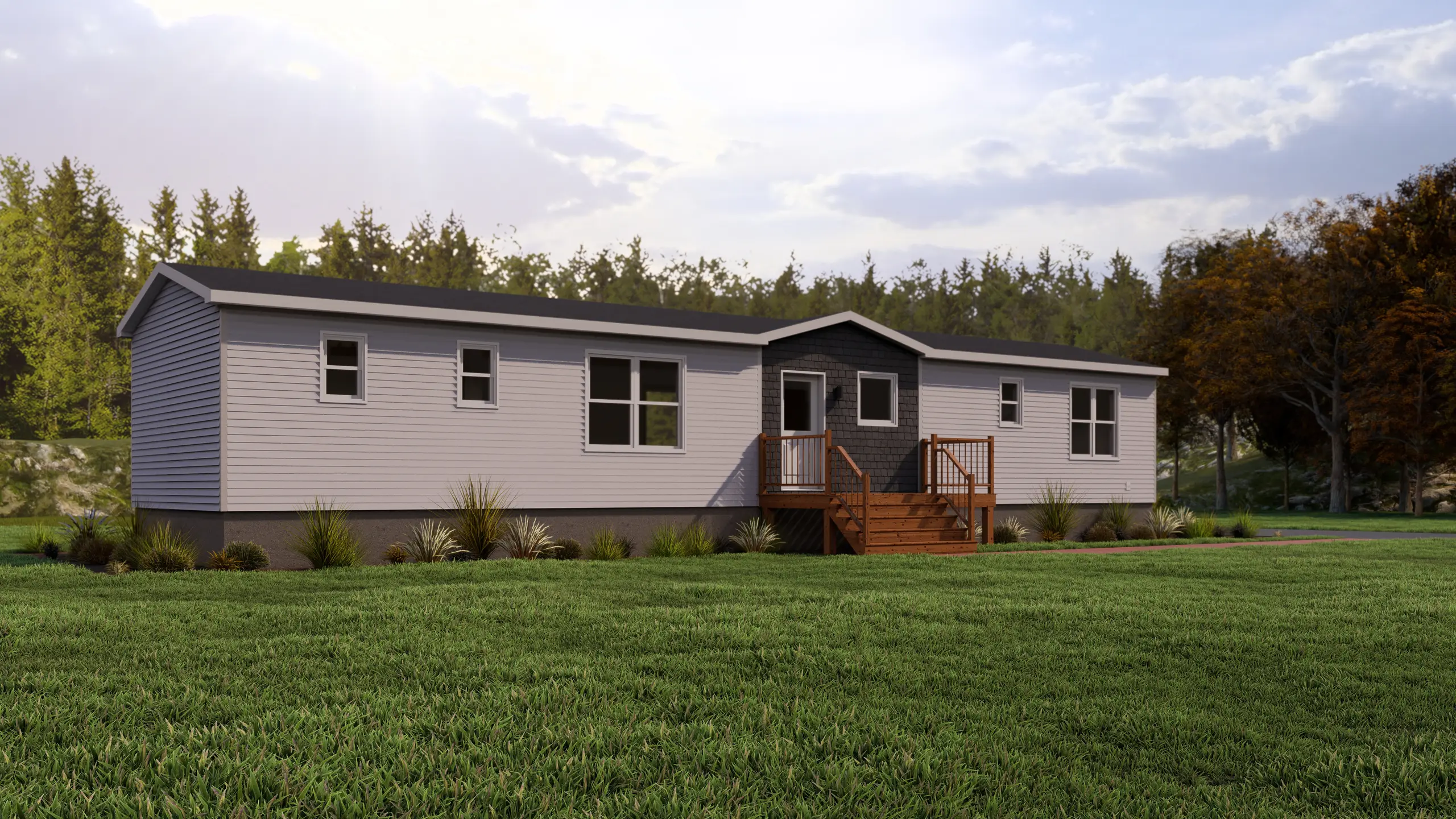 Front angled view of a modern mini home featuring light grey siding, a dark accent entry section, wood front steps, and landscaped foundation plantings. 