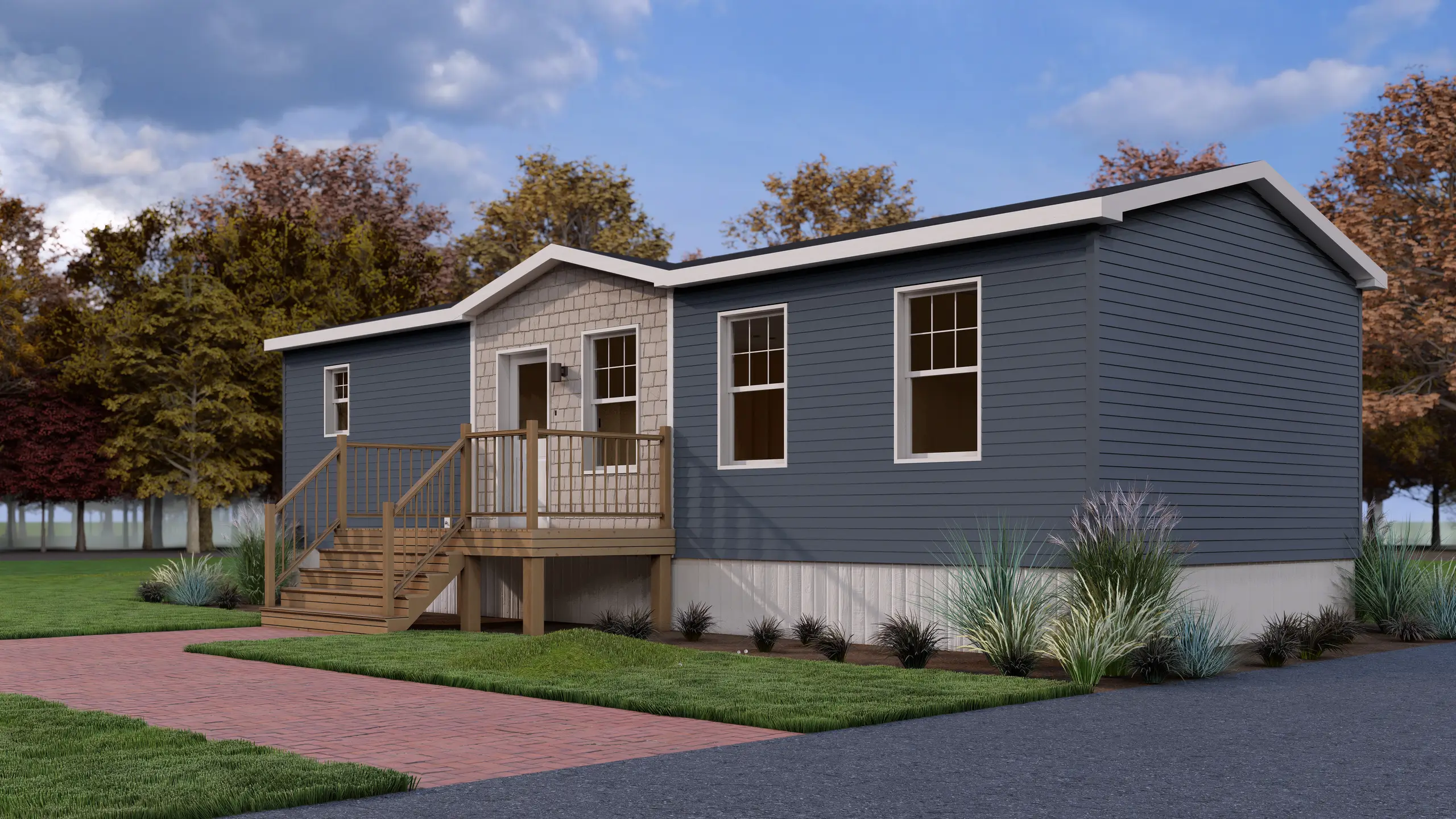 Front corner view of a contemporary mini home showcasing blue siding, a central entry porch, white trim, and low-maintenance landscaping. 
