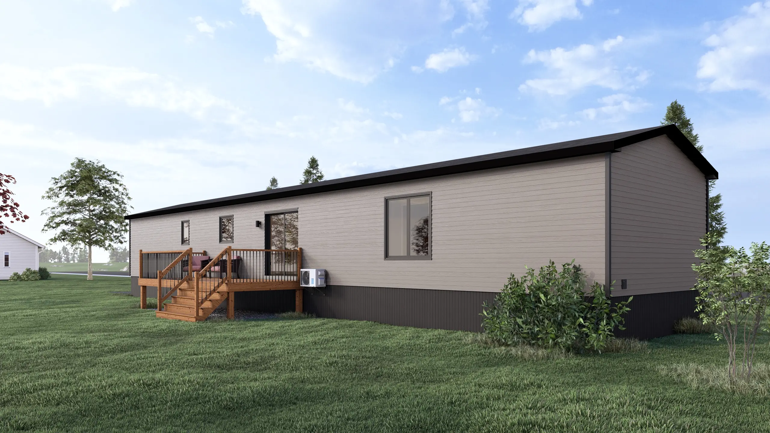 Rear angled view of a contemporary mini home featuring a raised wood deck, sliding patio door, light grey siding, and landscaped surroundings. 