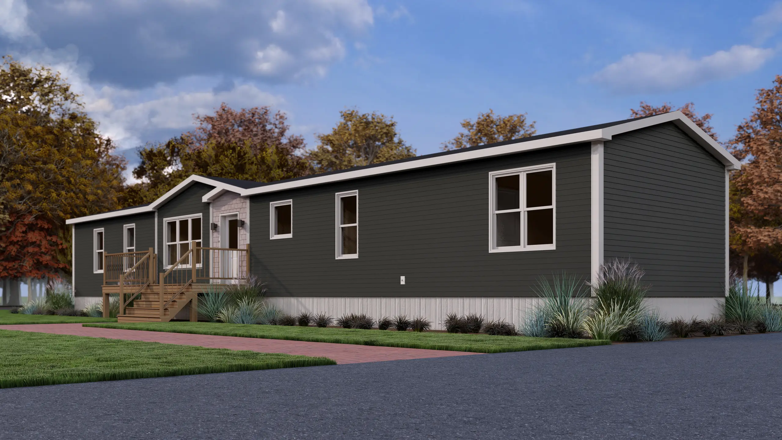 Front corner view of a modern mini home with dark exterior siding, a covered entrance, large windows, and a raised wood entry deck. 
