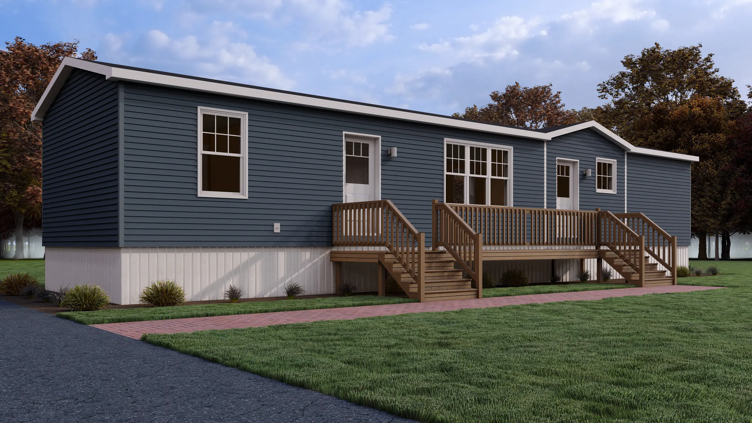 Front angled view of a blue modular home featuring a central raised deck, dual entry doors, white trim, and landscaped foundation plantings. 
