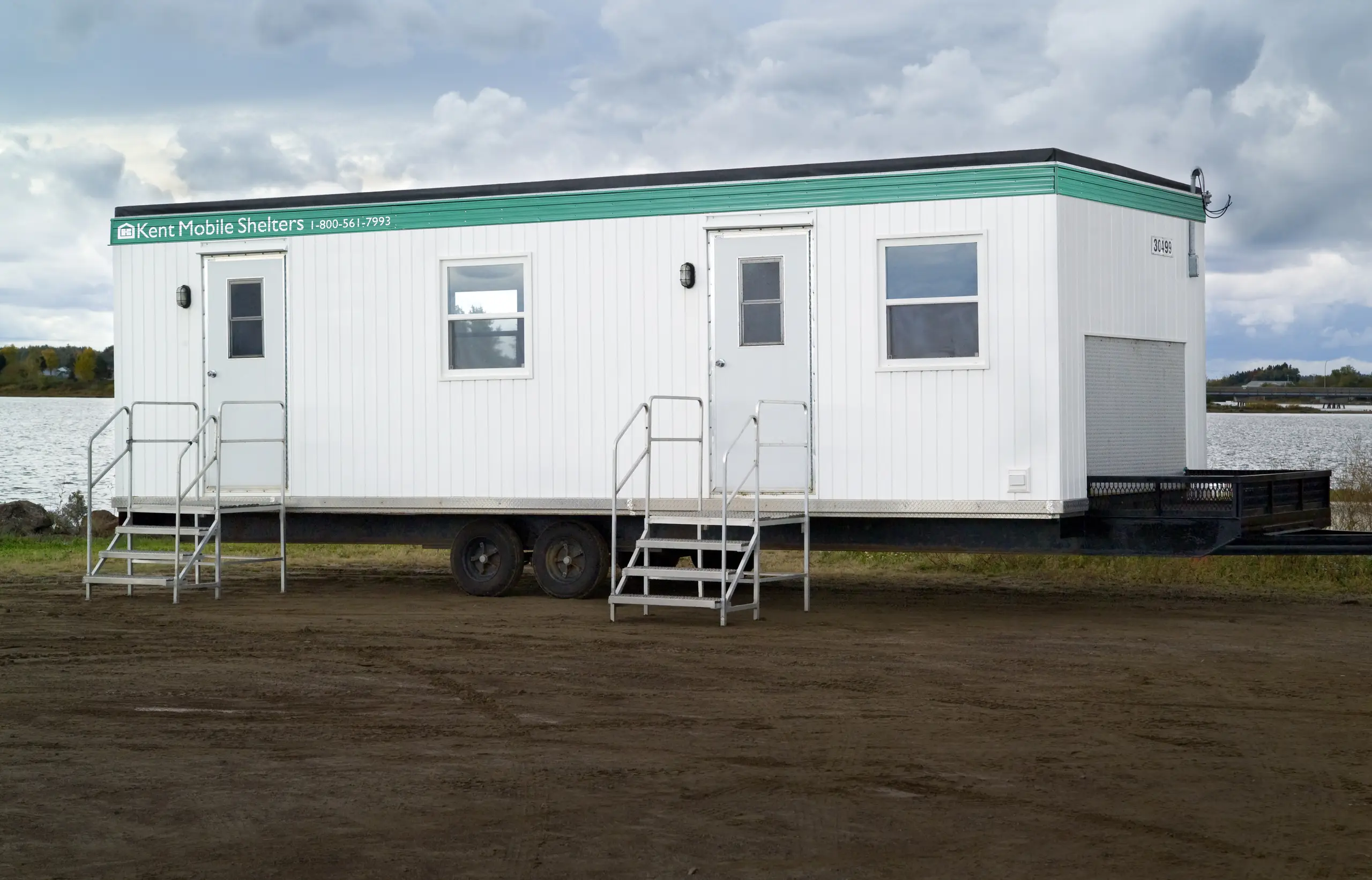 12x30 Kent Mobile Shelter unit with exterior stairs, platform deck, and entry door, designed for on-site workspace use. 