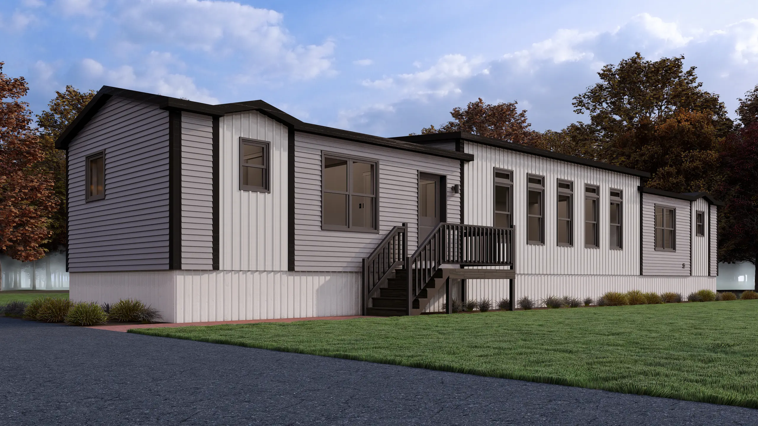 Front angled view of a contemporary modular home featuring light grey siding, black trim, a raised front entry deck, and expansive windows. 