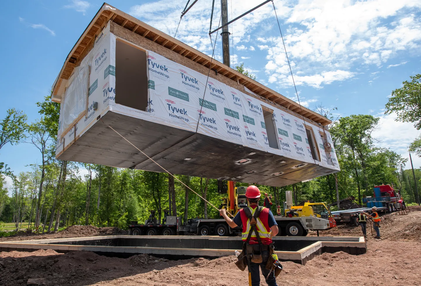 Modular home section being lifted into place on site during the Kent Homes installation process. 