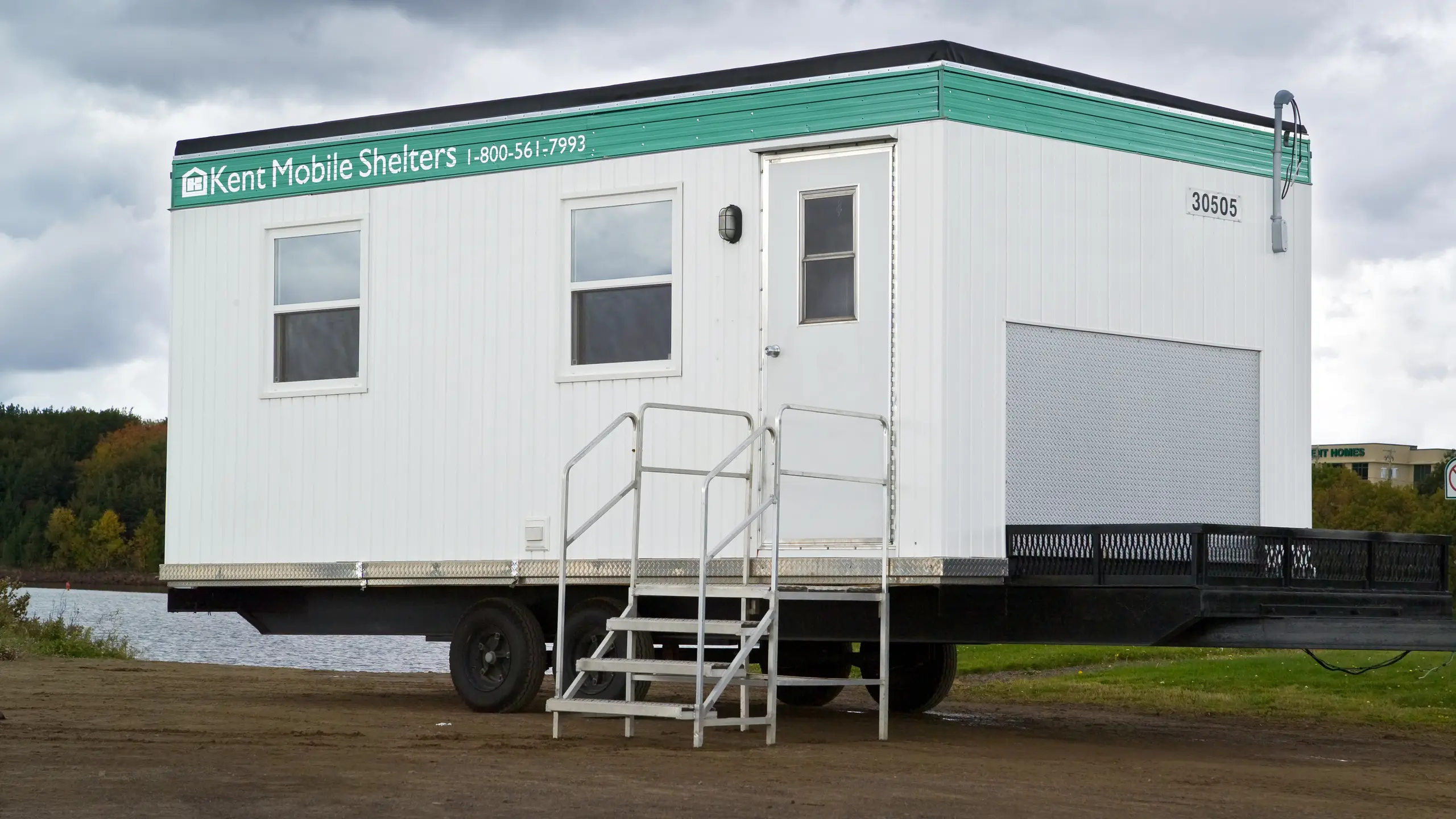 12x20 Kent Mobile Shelter unit with exterior stairs, platform deck, and entry door, designed for on-site workspace use. 