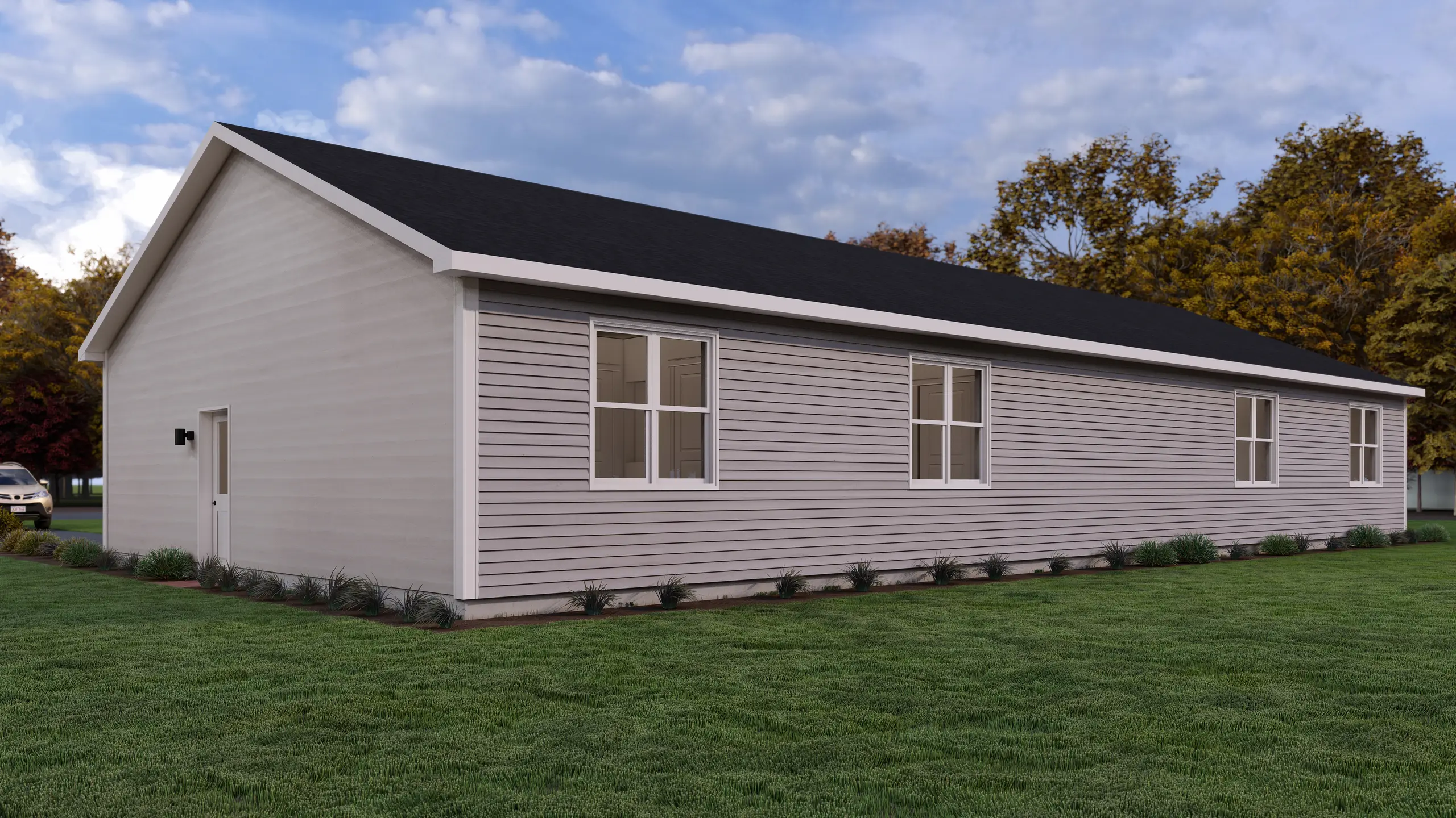 Side view of a modern duplex featuring low-maintenance siding, large windows, attached garages, and landscaped green space. 