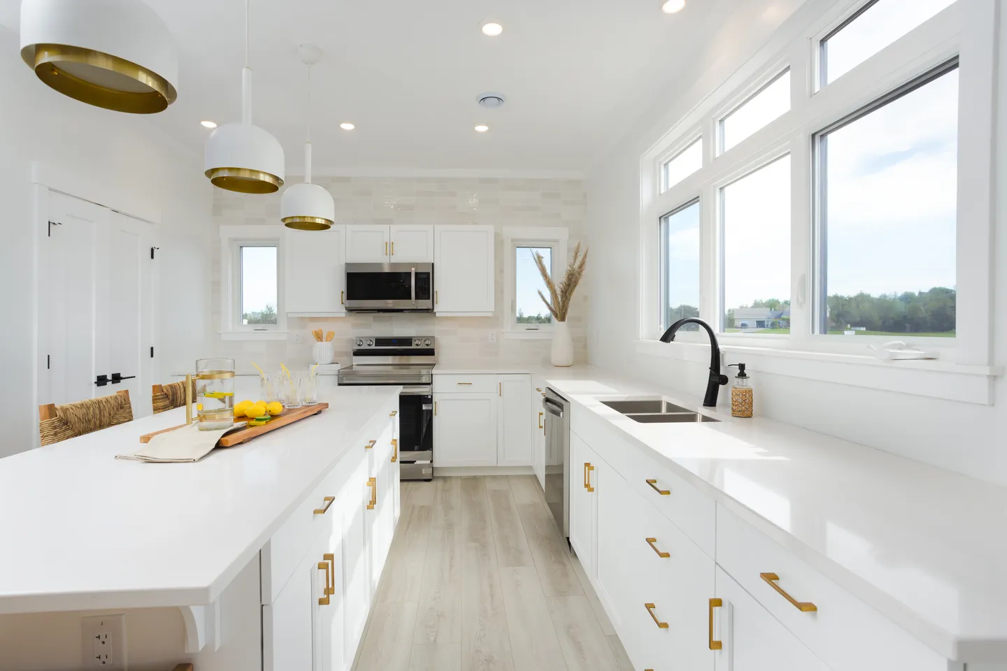 kent-homes-white-kitchen-gold-hardware-large-windows.jpg
