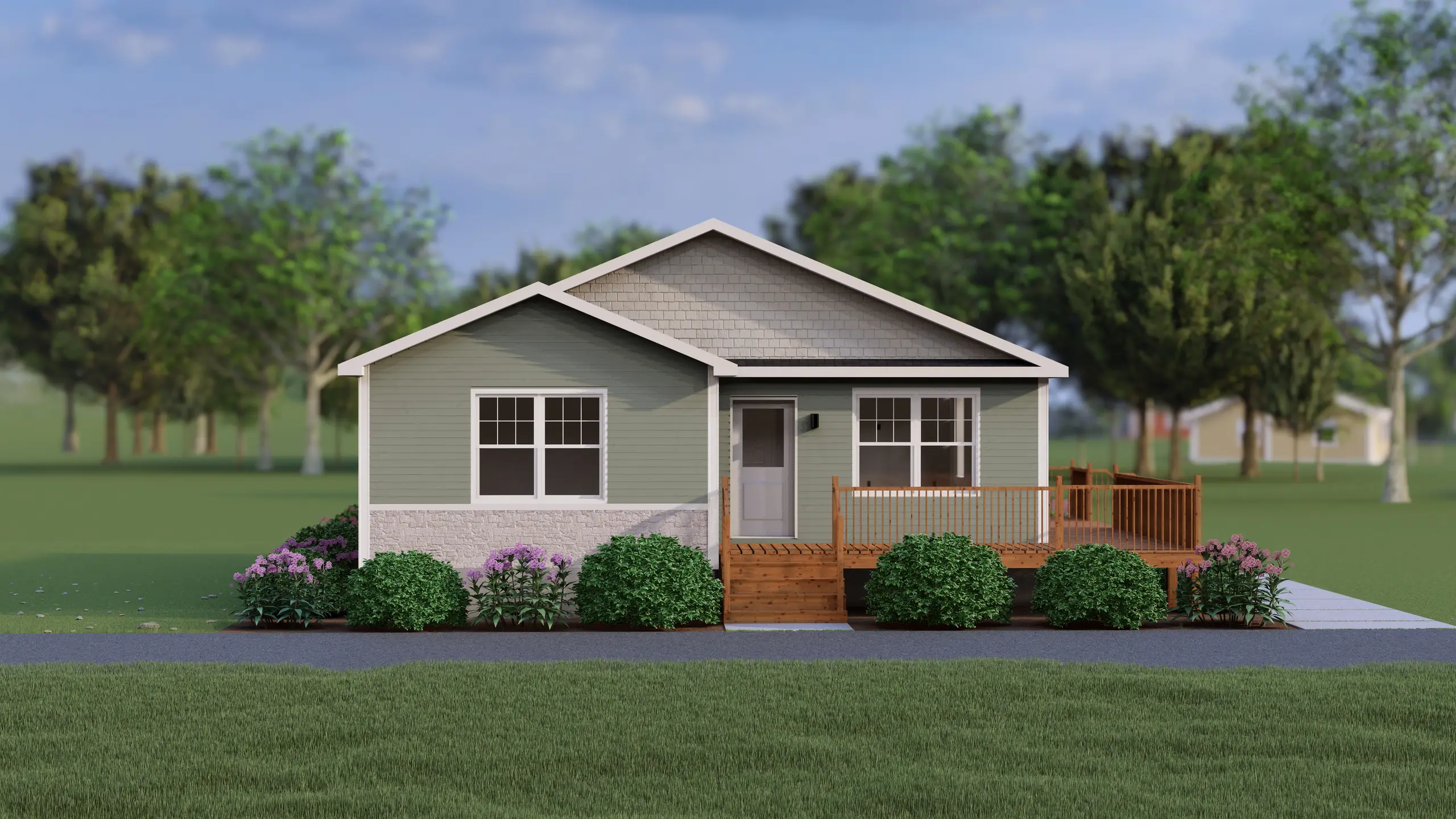 Front view of a light green bungalow with white stone accents, a covered entry deck, and symmetrical landscaping with shrubs and flowering plants. 