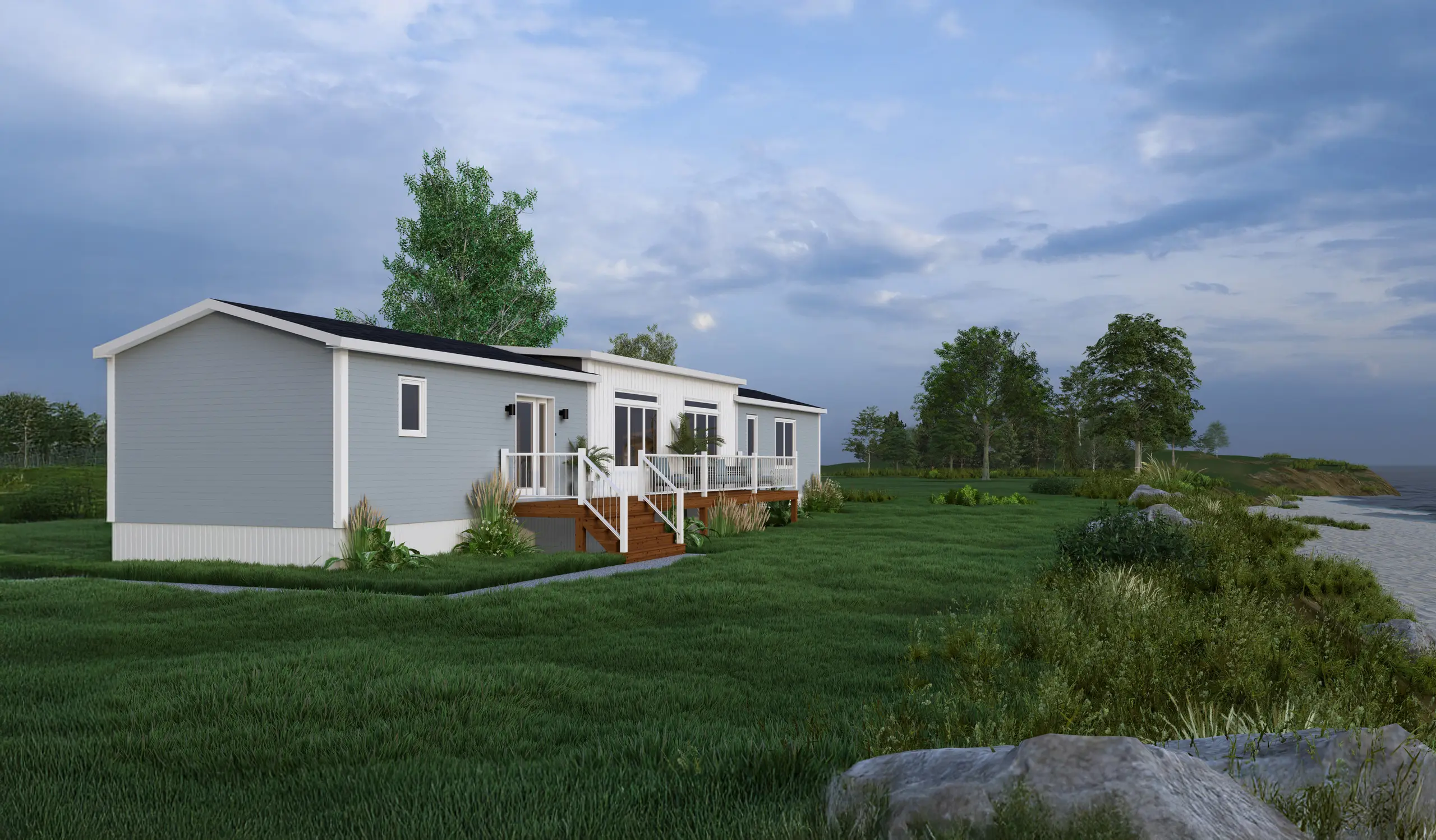 Rear angled view of a modern coastal mini home with a raised deck, expansive glazing, light grey exterior finishes, and waterfront views. 