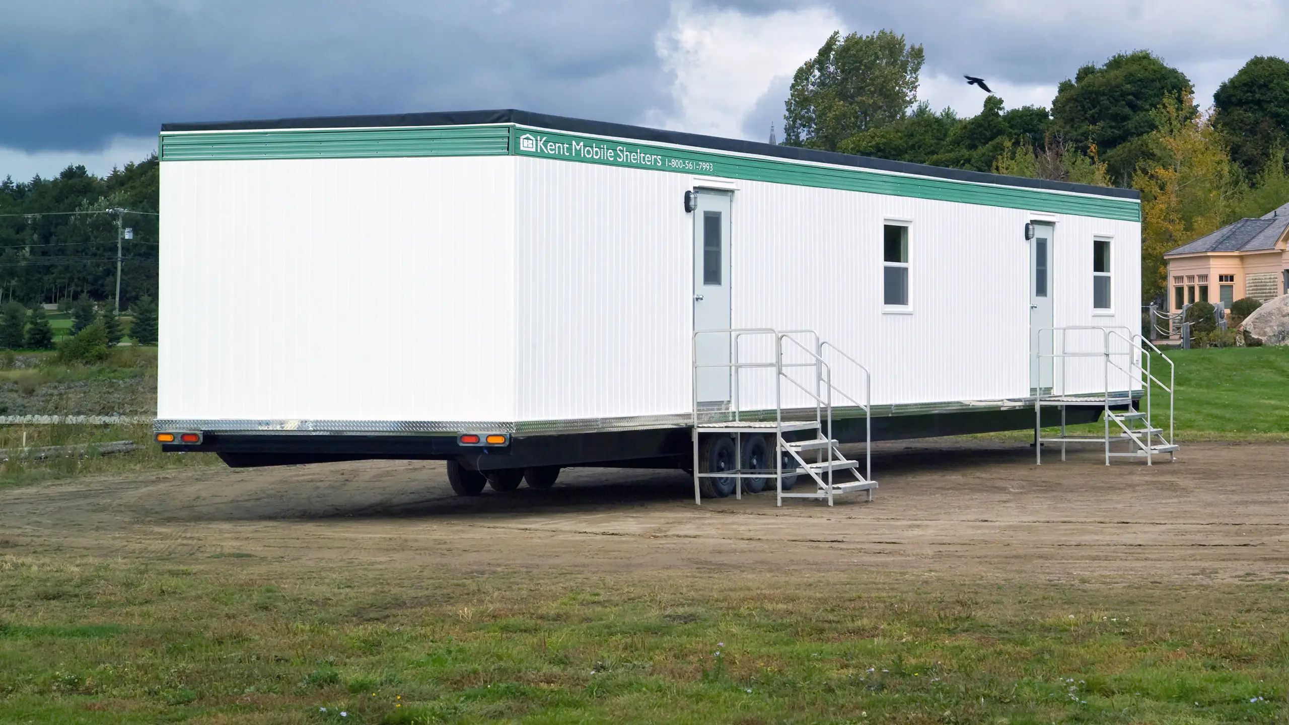 12x40 Kent Mobile Shelter unit with exterior stairs, platform deck, and entry door, designed for on-site workspace use. 