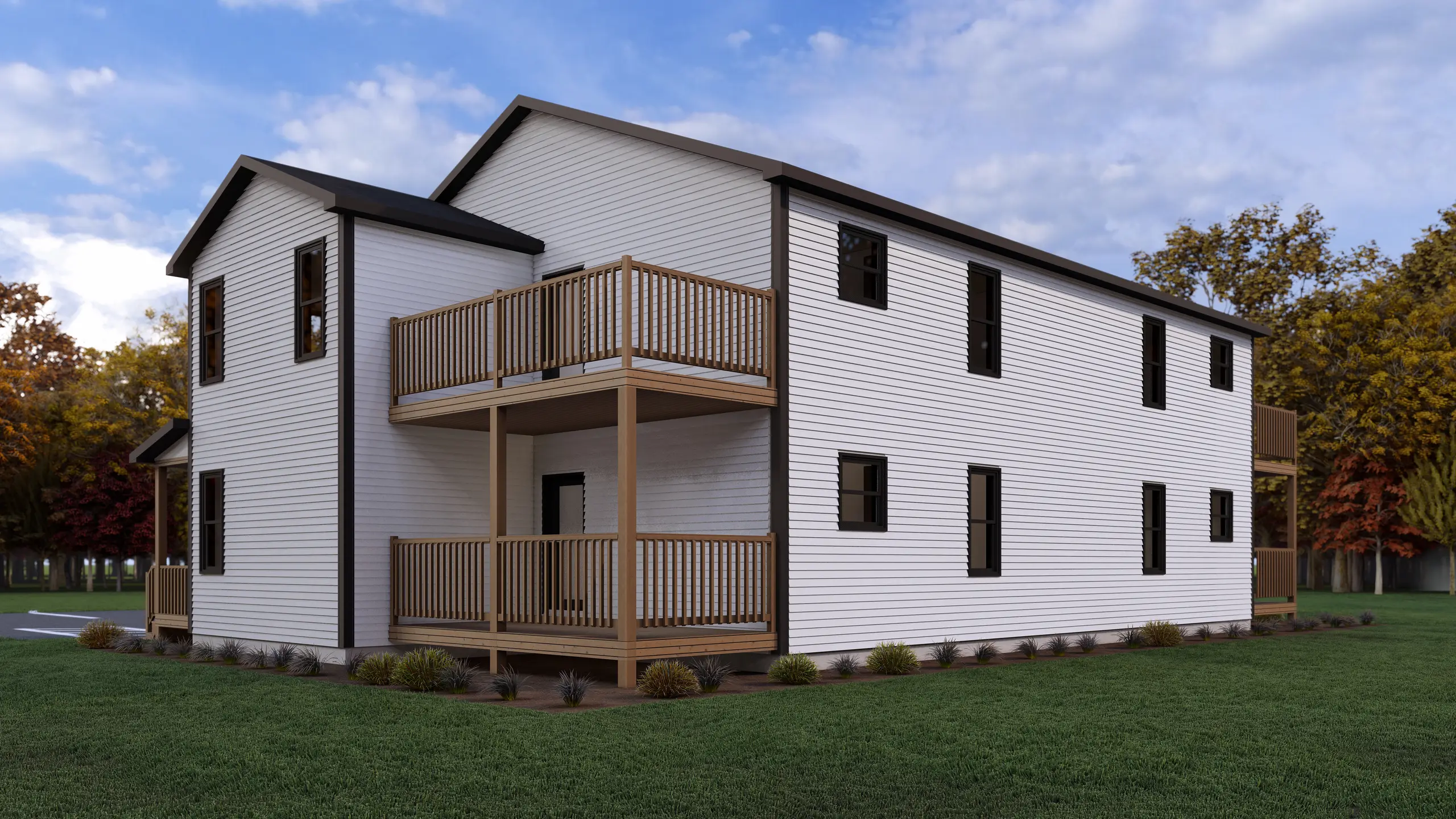 Rear view of a four-unit apartment building with stacked private balconies, white exterior siding, and landscaped green space surrounding the building. 