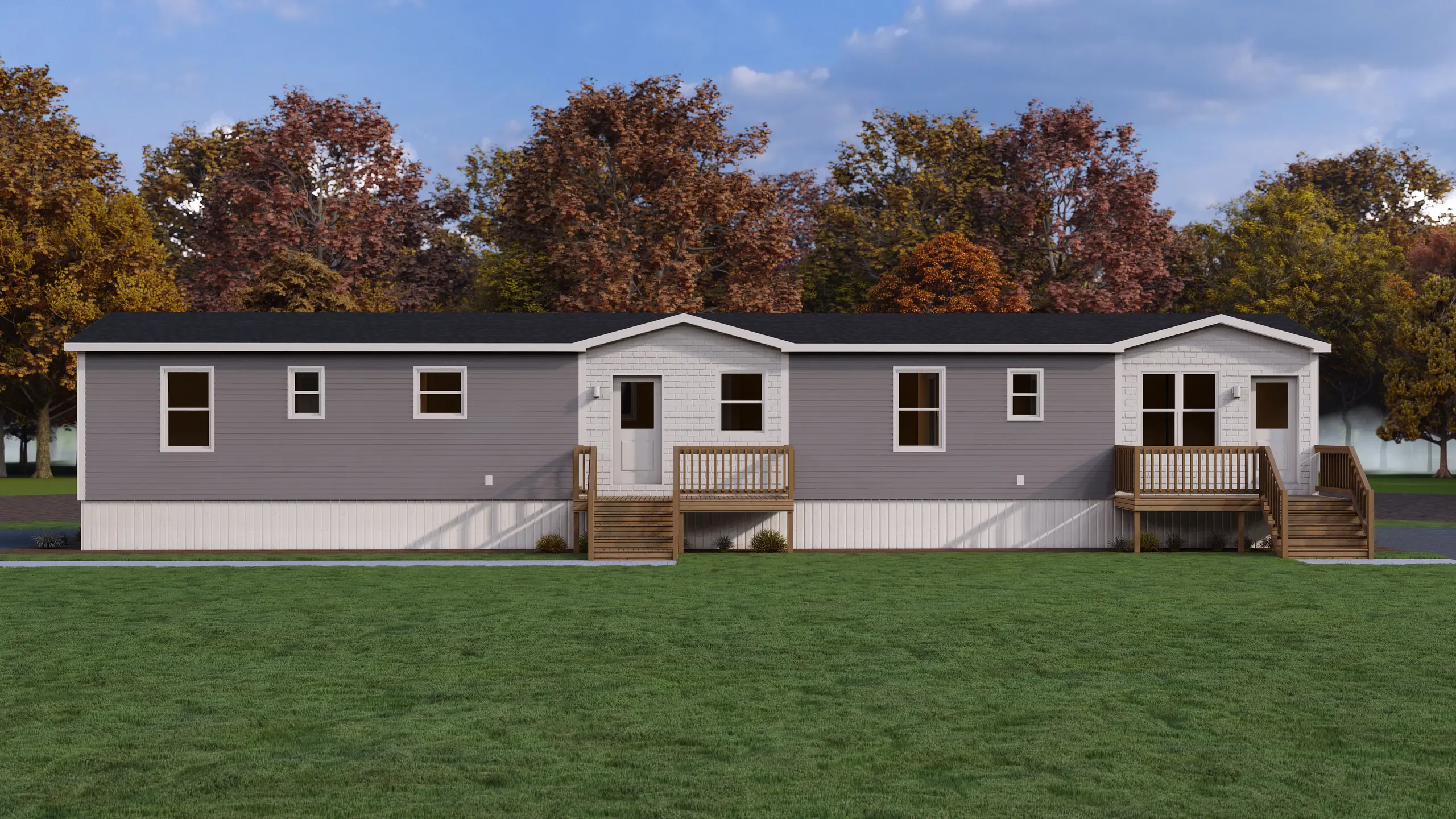 Modern duplex-style residential building with grey siding, white accent gables, private front entrances, elevated decks, and durable low-maintenance finishes. 