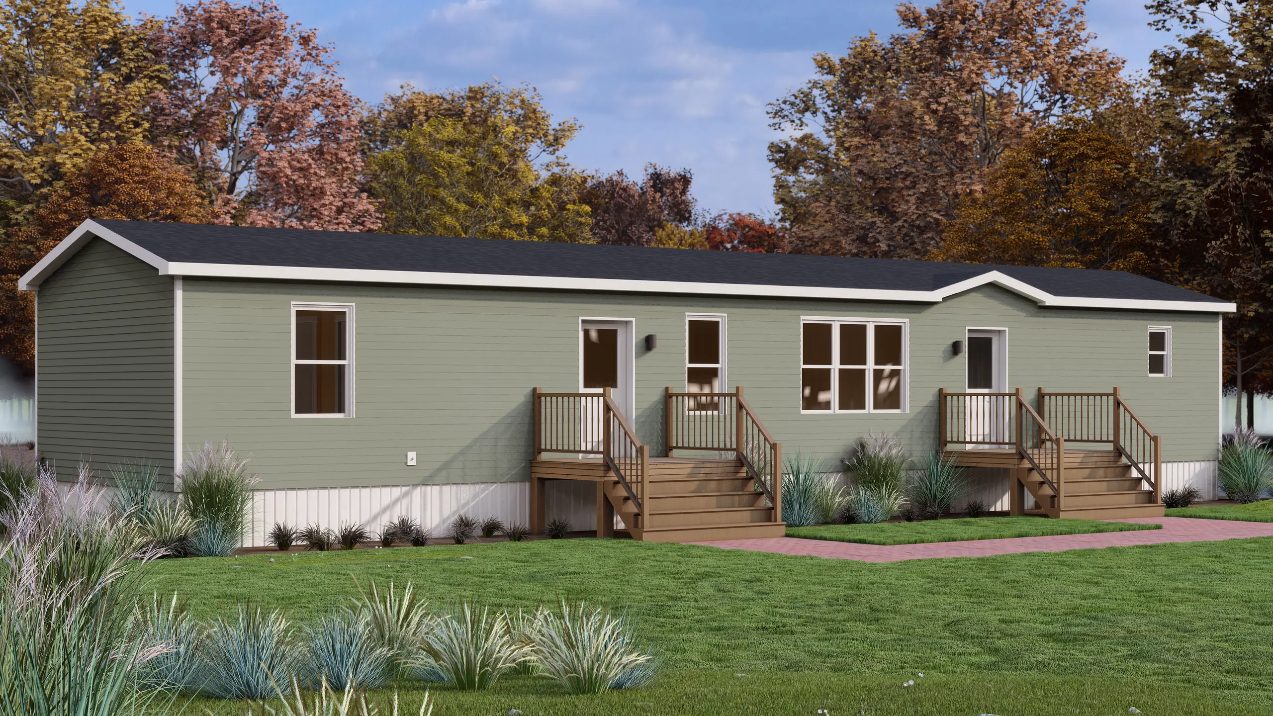 Long exterior view of a sage green mini home with dual entrances, wood stairs, white trim, and low-maintenance coastal gardens. 