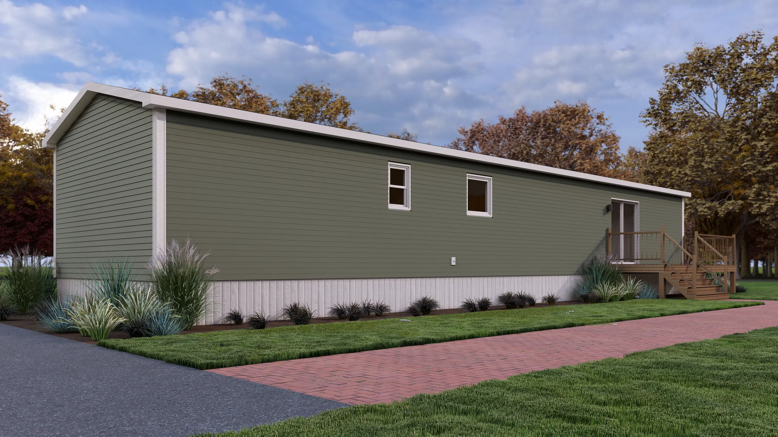 Side view of a contemporary mini home with sage green siding, rear deck access, white trim accents, and landscaped garden beds. 