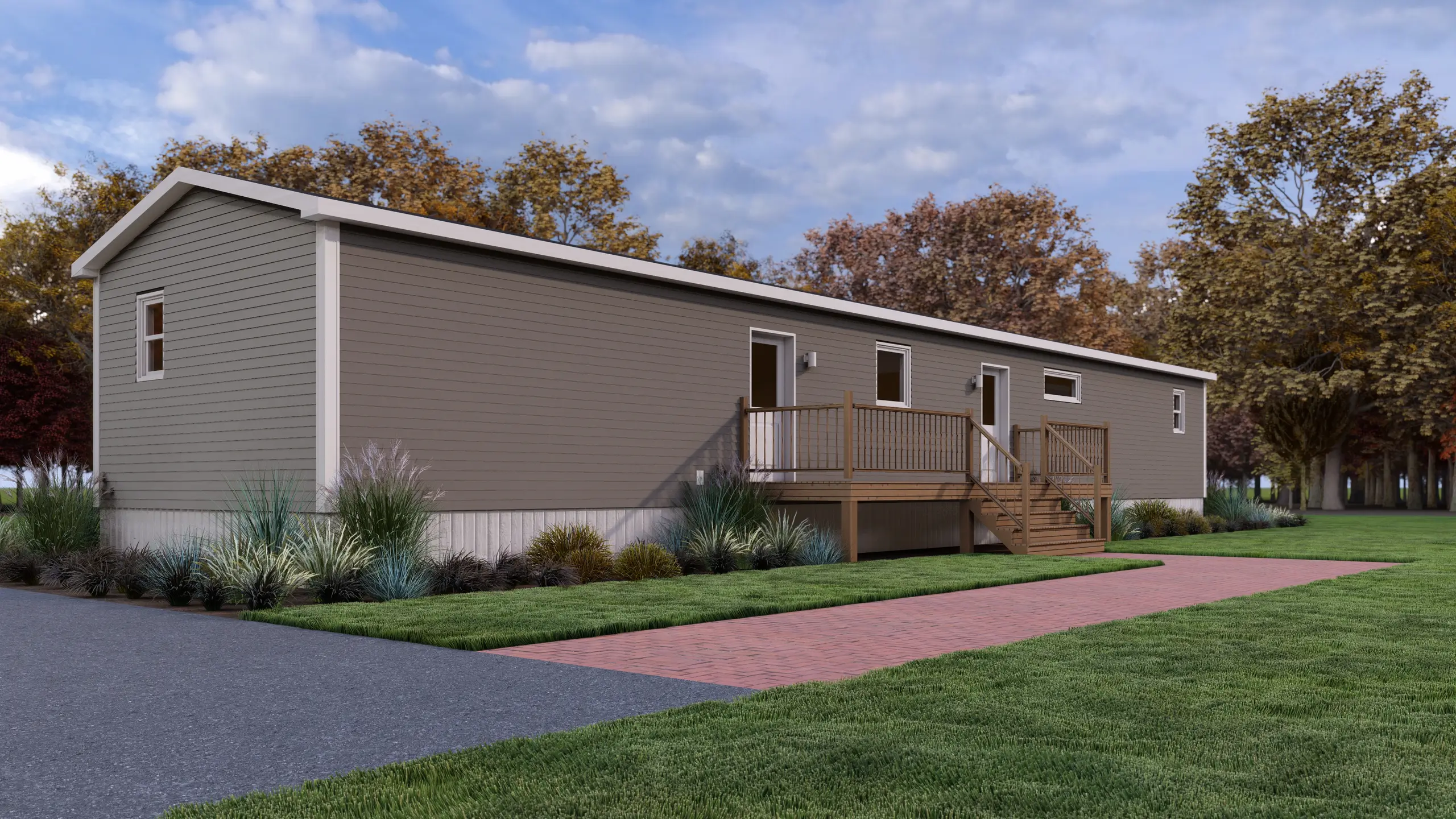 Side view of a contemporary mini home featuring taupe siding, a spacious rear deck, exterior entry doors, and low-maintenance landscaping. 