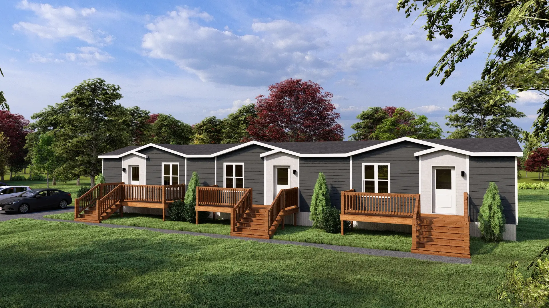 Modern four-unit residential building featuring private entrances, spacious front decks, dark exterior siding, landscaped grounds, and adjacent resident parking. 