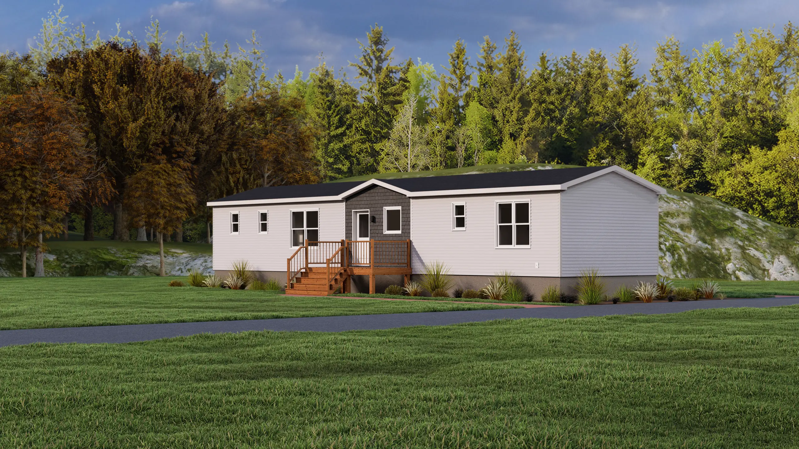 Front corner view of a modern mini home showcasing light grey siding, a central accent entrance, large windows, and surrounding landscaping. 