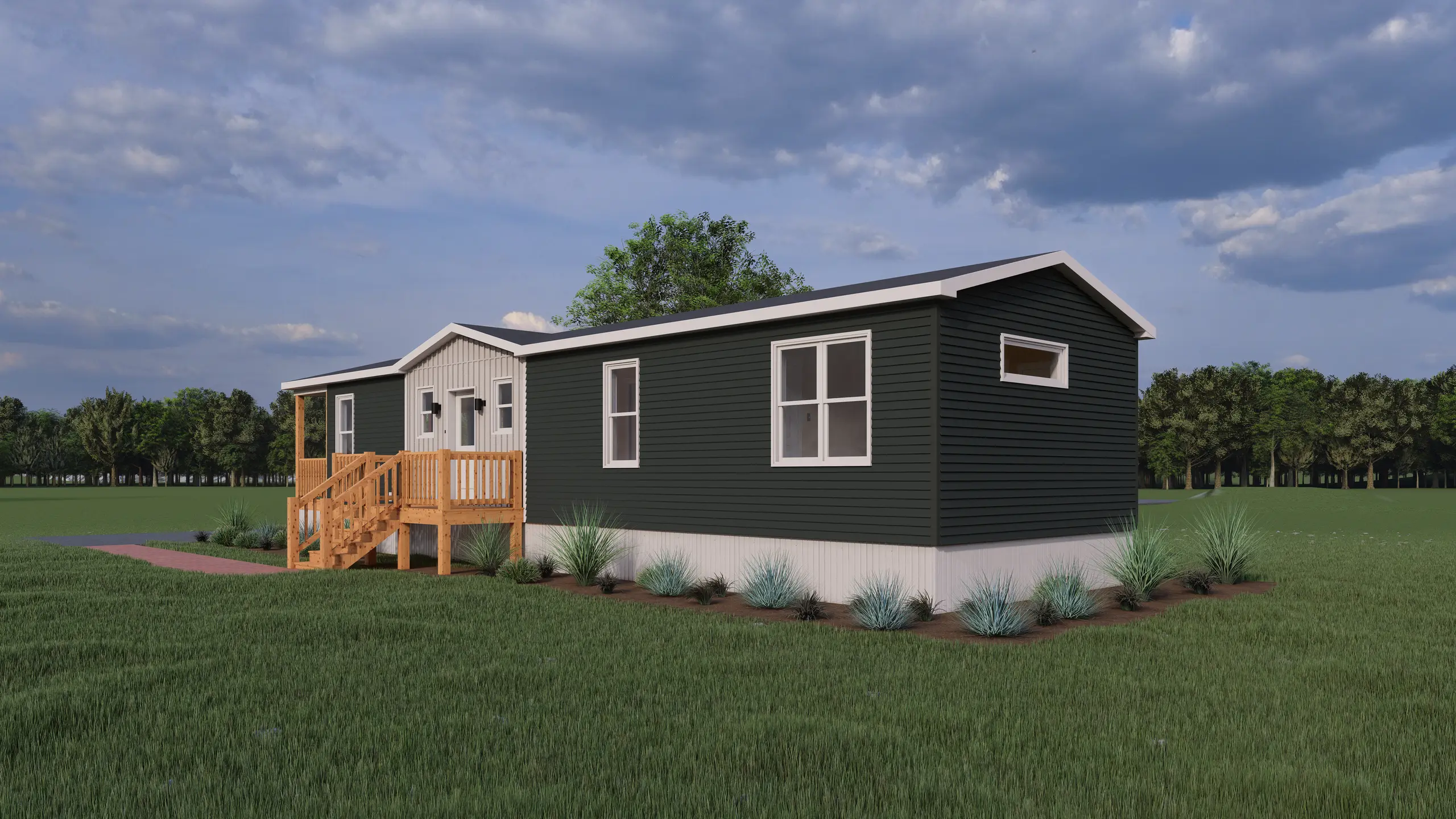 Rear angled view of a modern mini home featuring dark charcoal siding, large windows, a raised entry deck, and landscaped garden beds. 