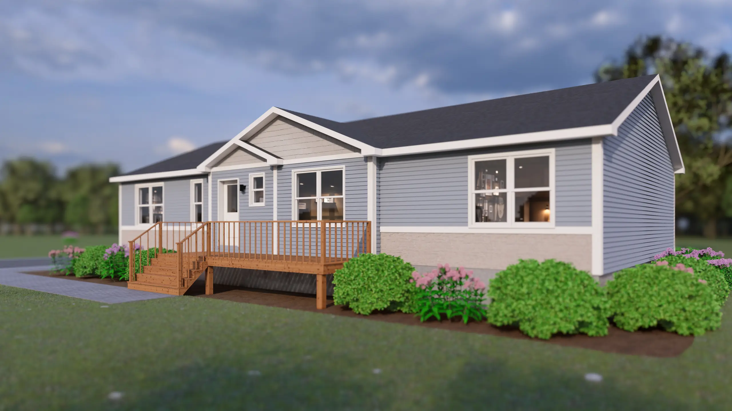 Modern bungalow featuring a covered front entry, spacious front deck, light blue siding, and vibrant landscaping with shrubs and flowering plants. 