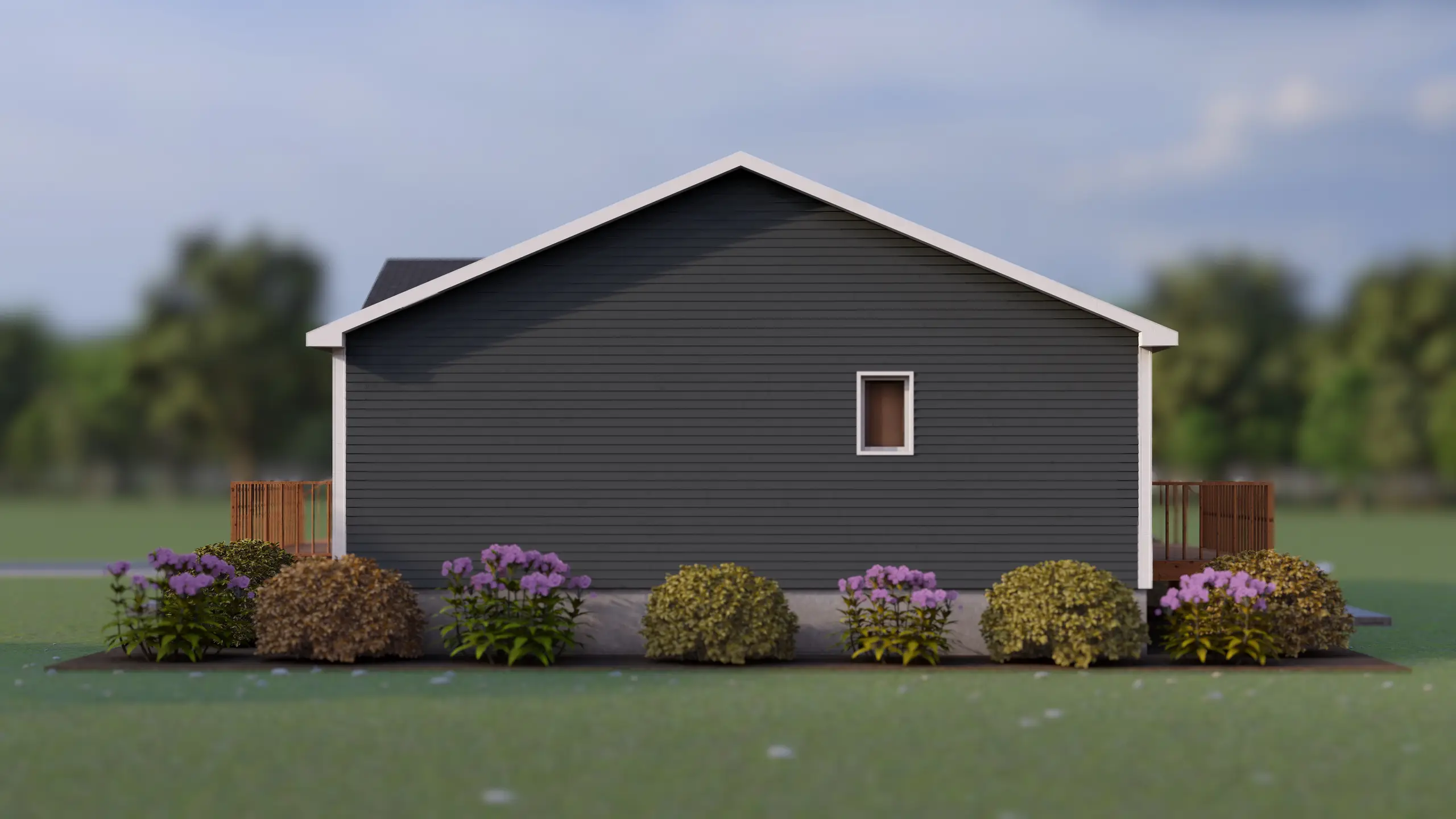 Side elevation of a modern bungalow with dark grey siding, a side entry deck, white trim, and landscaped flower beds along the home's exterior. 
