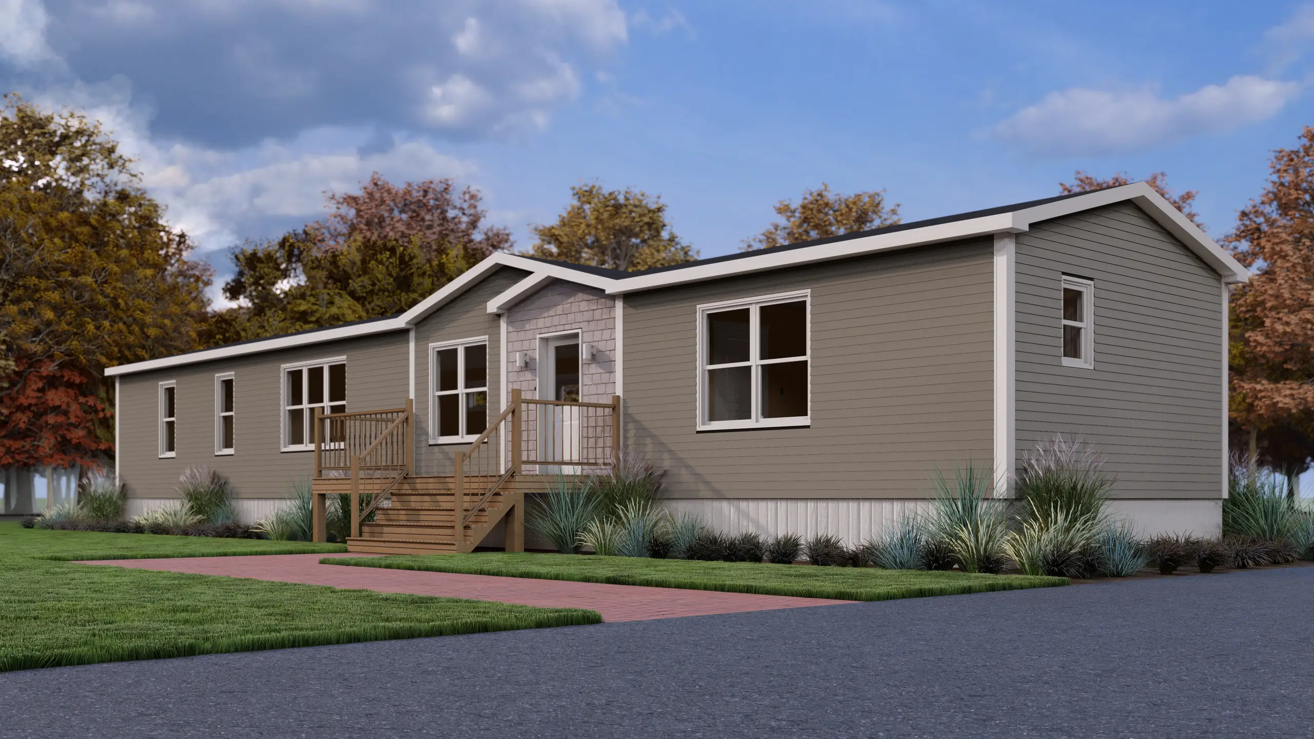 Front corner view of a modern mini home with a covered entry, large windows, taupe exterior siding, and wood front steps with railings. 