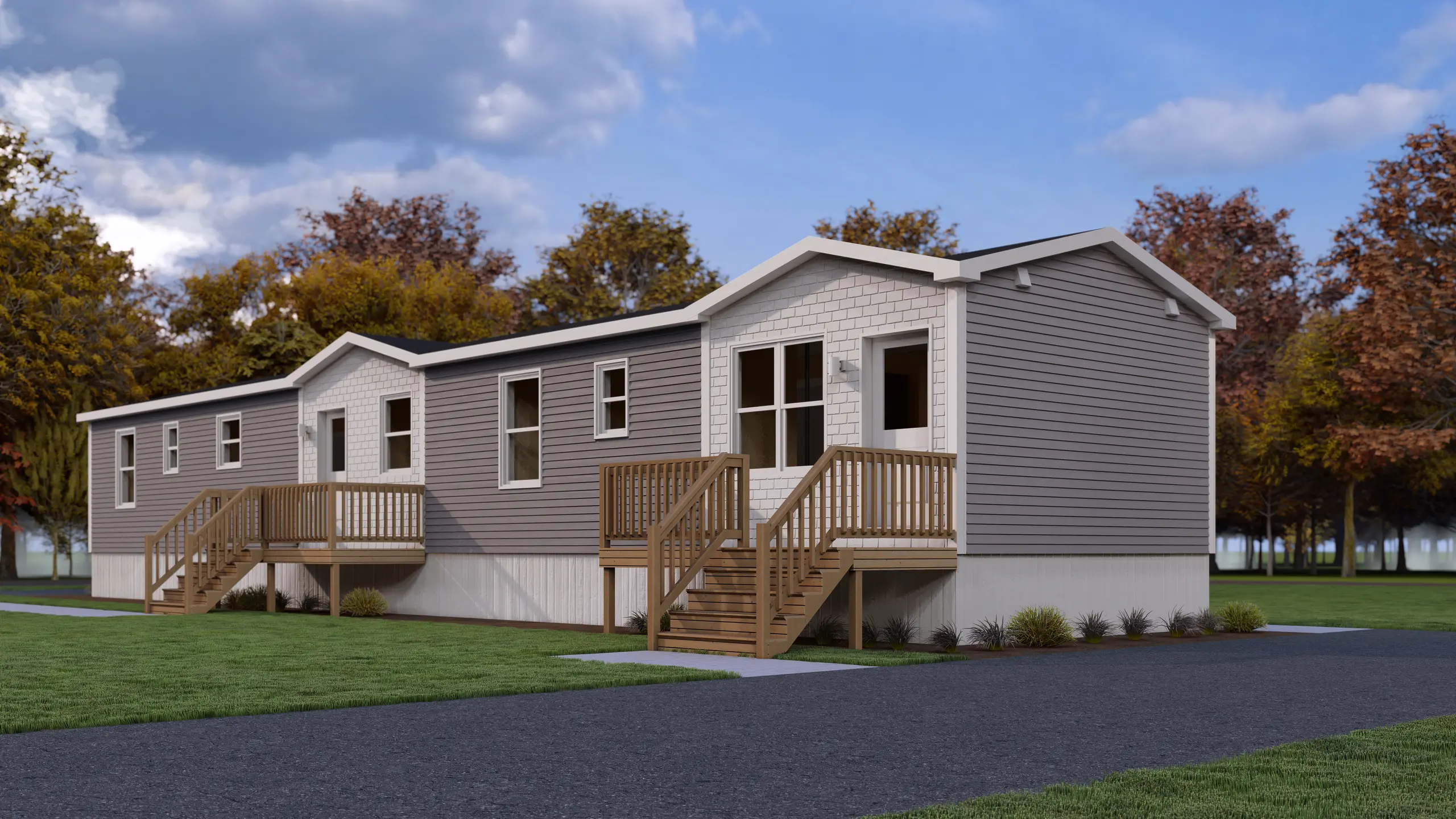 Contemporary two-unit residential building featuring private entrances, spacious front decks, grey exterior siding, and landscaped surroundings. 