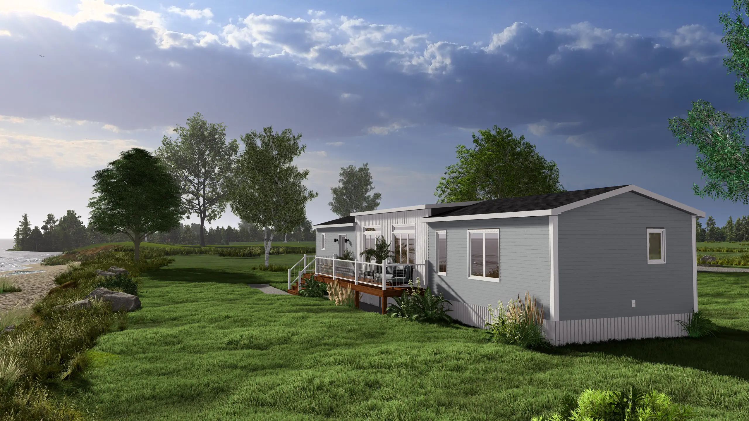 Front angled view of a contemporary coastal mini home featuring light grey siding, a spacious covered deck, large windows, and oceanfront surroundings. 